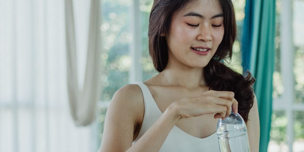 Person holding a bottle of chlorophyll water